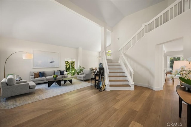5 Bergamo, Irvine, CA 92614 - living room featuring hardwood / wood-style floors, stairs, and high vaulted ceiling