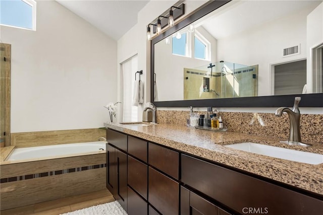 5 Bergamo, Irvine, CA 92614 - full bathroom with vaulted ceiling, double vanity, a bath, a shower stall, and wood finished floors