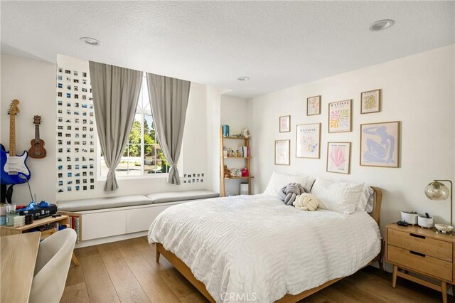 5 Bergamo, Irvine, CA 92614 - bedroom featuring wood-type flooring, a textured ceiling, and recessed lighting