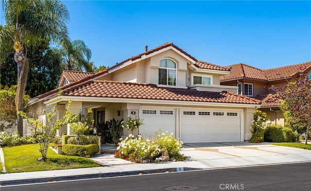 5 Bergamo, Irvine, CA 92614 - mediterranean / spanish-style house featuring stucco siding, concrete driveway, and a tile roof