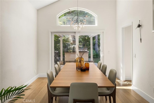 5 Bergamo, Irvine, CA 92614 - dining space featuring a chandelier, plenty of natural light, light wood-style flooring, and a towering ceiling