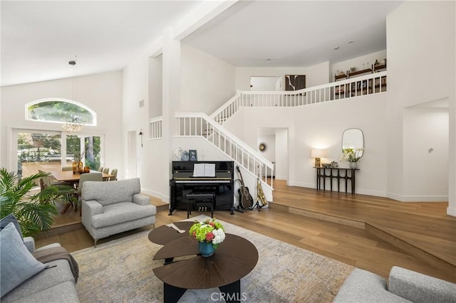 5 Bergamo, Irvine, CA 92614 - living room featuring a towering ceiling, stairway, and wood finished floors