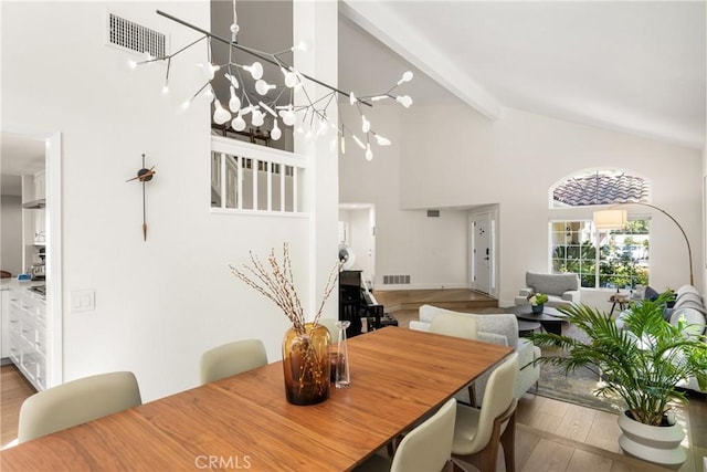 5 Bergamo, Irvine, CA 92614 - dining space featuring high vaulted ceiling, beamed ceiling, a chandelier, and wood finished floors