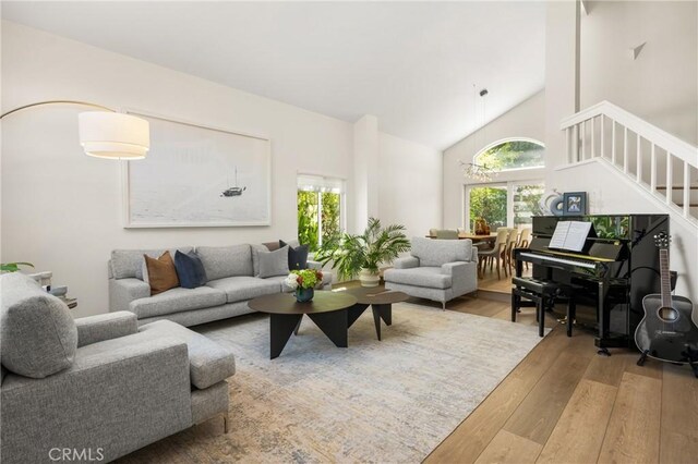 5 Bergamo, Irvine, CA 92614 - living room featuring wood finished floors, stairway, and high vaulted ceiling