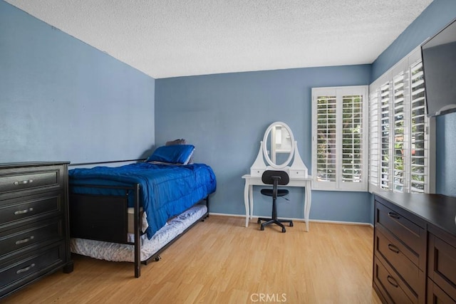 2367 Archwood Ln Unit 171, Simi Valley, CA 93063 - bedroom featuring light wood-type flooring and a textured ceiling