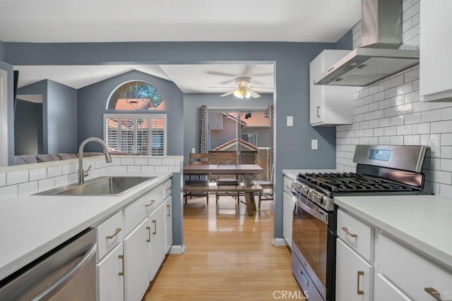 2367 Archwood Ln Unit 171, Simi Valley, CA 93063 - kitchen featuring wall chimney exhaust hood, stainless steel appliances, light wood-style floors, decorative backsplash, and light countertops