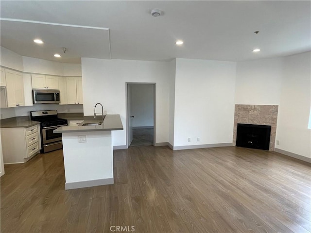 14914 Hamlin St Unit 105, Van Nuys, CA 91411 - kitchen with stainless steel appliances, open floor plan, dark wood-style flooring, white cabinetry, and recessed lighting