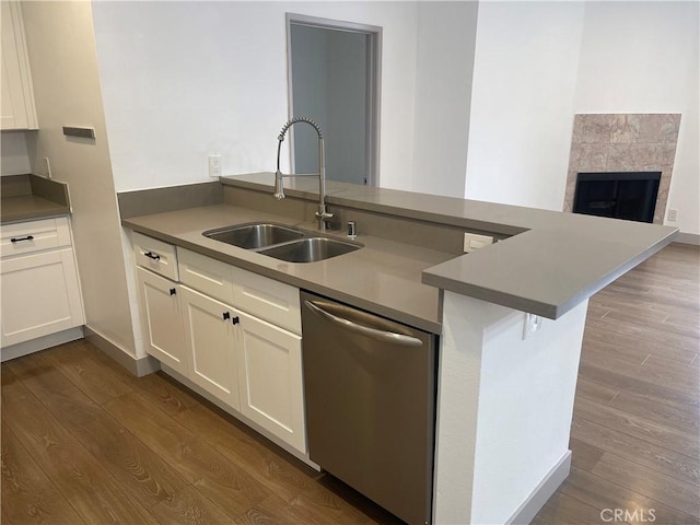14914 Hamlin St Unit 105, Van Nuys, CA 91411 - kitchen with dishwasher, a peninsula, dark wood-style flooring, and white cabinets