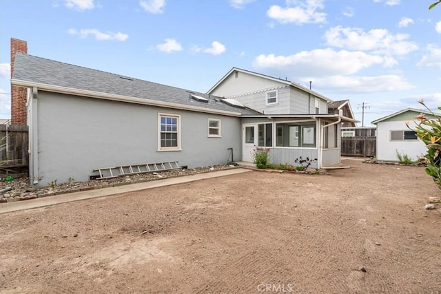 1851 Pacific Ave, Cayucos, CA 93430 - rear view of property with a sunroom, a chimney, stucco siding, and a shingled roof