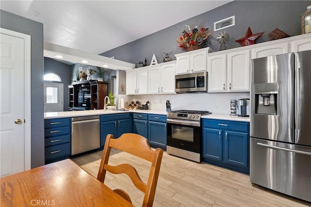 3312 Poplar St, Rosamond, CA 93560 - kitchen featuring stainless steel appliances, blue cabinetry, white cabinetry, light wood-style floors, and recessed lighting