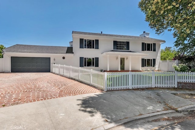 9500 Texhoma Ave, Northridge, CA 91325 - view of front of property with decorative driveway, a garage, a fenced front yard, and a chimney