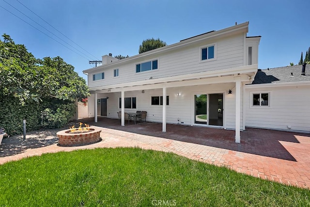 9500 Texhoma Ave, Northridge, CA 91325 - back of property with an outdoor fire pit, a patio, a chimney, and a yard