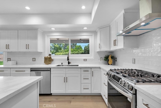 9500 Texhoma Ave, Northridge, CA 91325 - kitchen featuring wall chimney exhaust hood, appliances with stainless steel finishes, backsplash, white cabinetry, and recessed lighting