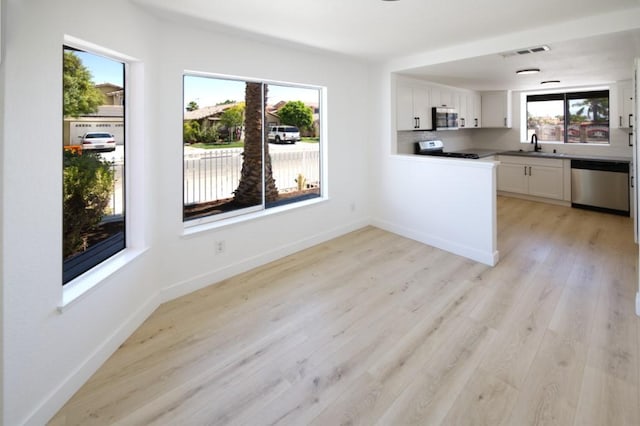 1564 Ashbury Way, Perris, CA 92571 - kitchen featuring appliances with stainless steel finishes, white cabinets, and light wood finished floors