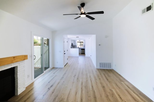 1564 Ashbury Way, Perris, CA 92571 - unfurnished living room with light wood-type flooring, vaulted ceiling, ceiling fan, and a brick fireplace