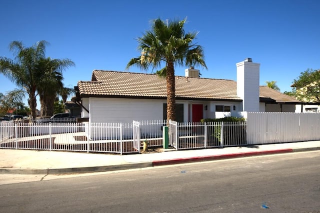 1564 Ashbury Way, Perris, CA 92571 - view of front of home with a tiled roof, a fenced front yard, and a chimney