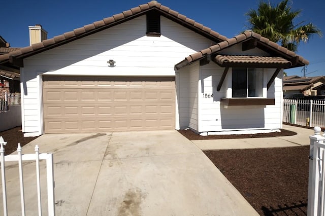 1564 Ashbury Way, Perris, CA 92571 - view of front facade featuring a tile roof, driveway, an attached garage, and a chimney