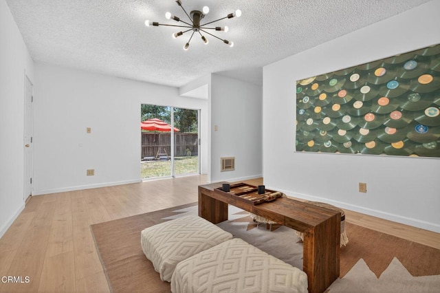 901 Drown Ave, Ojai, CA 93023 - living area featuring a textured ceiling, a chandelier, and wood finished floors