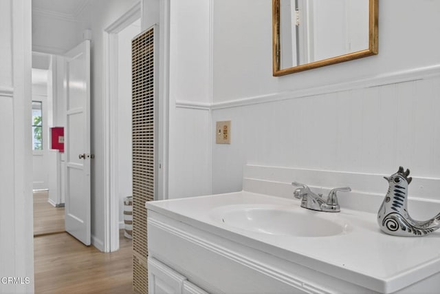 901 Drown Ave, Ojai, CA 93023 - bathroom featuring vanity, wood finished floors, ornamental molding, a heating unit, and a wainscoted wall