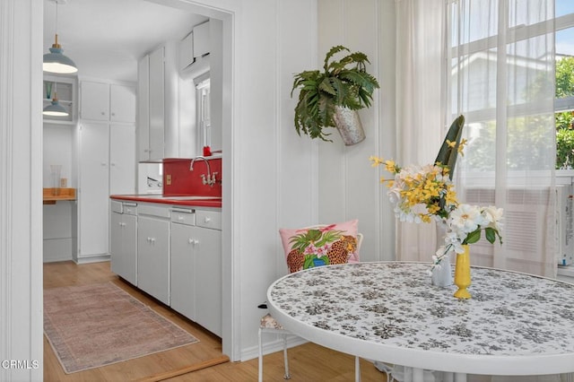 901 Drown Ave, Ojai, CA 93023 - kitchen featuring light wood-style floors, a decorative wall, and white cabinetry