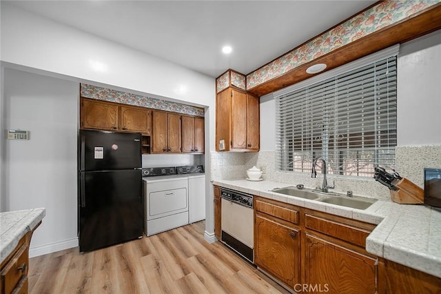 957 W Myrrh St, Compton, CA 90220 - kitchen with freestanding refrigerator, dishwasher, washing machine and clothes dryer, light wood-style flooring, and backsplash