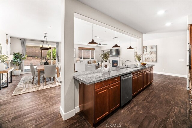 11810 Sanderling Way, Jurupa Valley, CA 91752 - kitchen with stainless steel dishwasher, dark wood-type flooring, a kitchen island with sink, decorative light fixtures, and open floor plan