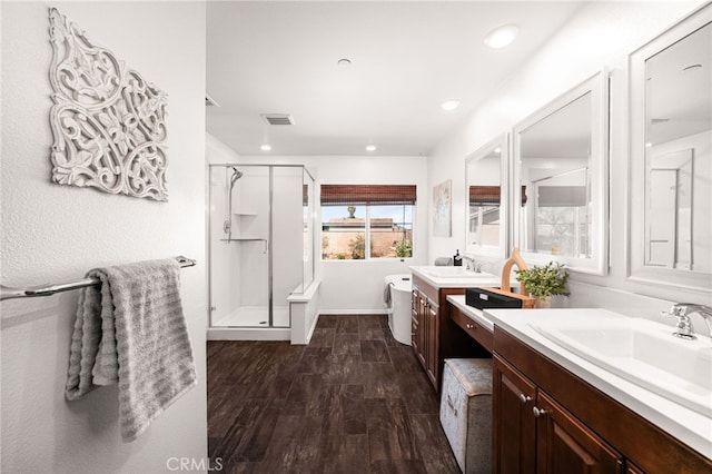 11810 Sanderling Way, Jurupa Valley, CA 91752 - full bath with a stall shower, two vanities, wood finished floors, recessed lighting, and a tub to relax in