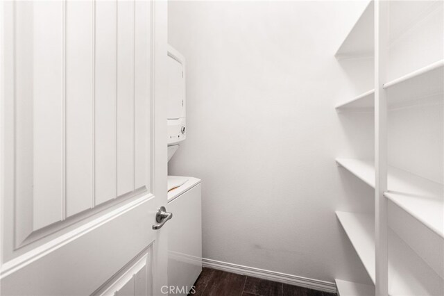 11810 Sanderling Way, Jurupa Valley, CA 91752 - laundry room featuring stacked washer and clothes dryer and dark wood finished floors