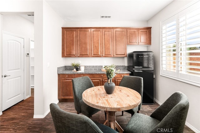 11810 Sanderling Way, Jurupa Valley, CA 91752 - kitchen with freestanding refrigerator, brown cabinetry, and plenty of natural light