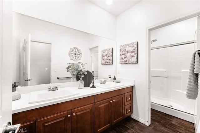 11810 Sanderling Way, Jurupa Valley, CA 91752 - bathroom featuring double vanity, wood finished floors, and a stall shower