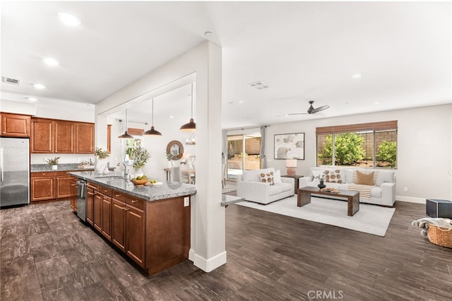 11810 Sanderling Way, Jurupa Valley, CA 91752 - kitchen with appliances with stainless steel finishes, open floor plan, a ceiling fan, dark stone countertops, and recessed lighting