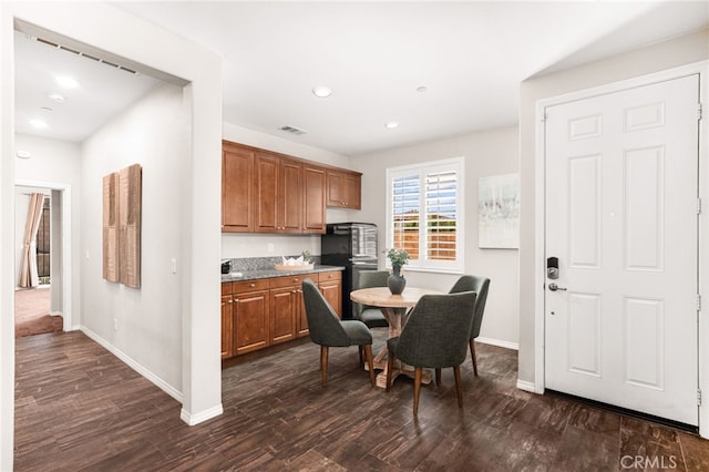 11810 Sanderling Way, Jurupa Valley, CA 91752 - kitchen with dark wood finished floors, brown cabinetry, and recessed lighting