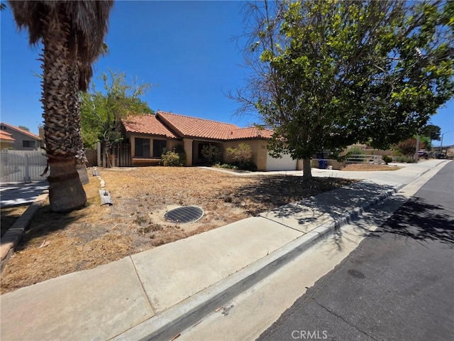38318 Miramonte Ave, Palmdale, CA 93551 - view of front of house with a tiled roof, a garage, driveway, and stucco siding