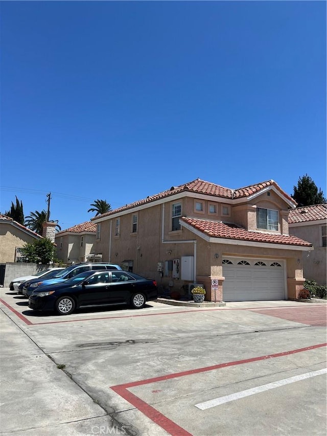 12143 Ferris Rd, El Monte, CA 91732 - view of front of property featuring a tiled roof, stucco siding, and driveway