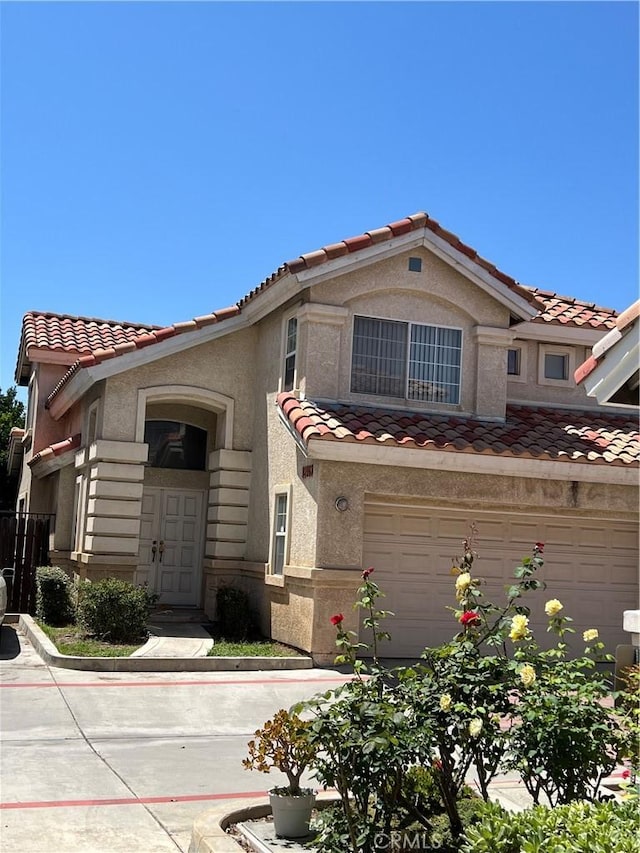 12143 Ferris Rd, El Monte, CA 91732 - view of front of home featuring a tiled roof, stucco siding, and an attached garage