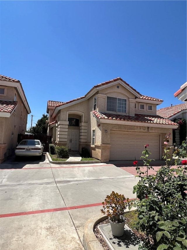 12143 Ferris Rd, El Monte, CA 91732 - mediterranean / spanish home featuring a tile roof, a garage, stucco siding, and concrete driveway