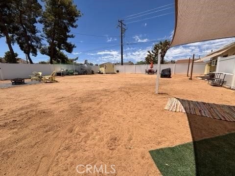 55687 Onaga Trl, Yucca Valley, CA 92284 - fenced backyard featuring a fire pit