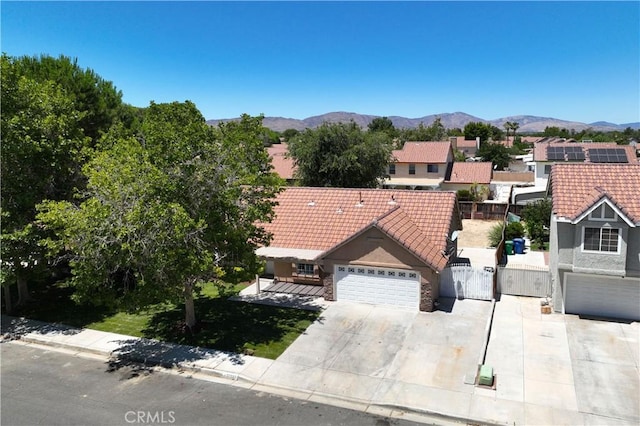 37537 Sabal Ct, Palmdale, CA 93552 - view of front of home with a gate, a tiled roof, driveway, and a mountain view