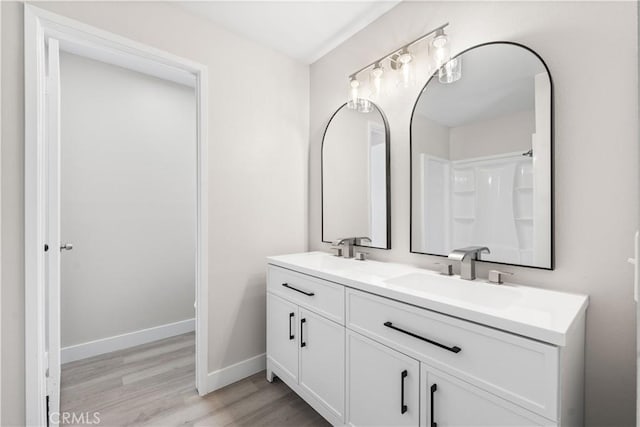 37537 Sabal Ct, Palmdale, CA 93552 - bathroom featuring double vanity and wood finished floors
