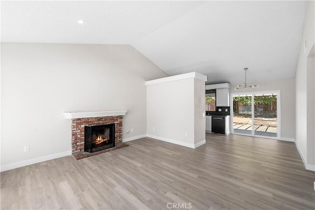 37537 Sabal Ct, Palmdale, CA 93552 - unfurnished living room with a fireplace, wood finished floors, and vaulted ceiling