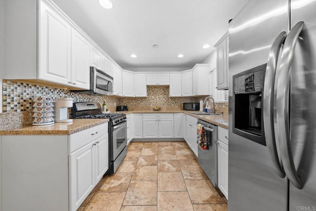 1203 Fifth Ave, Chula Vista, CA 91911 - kitchen with stainless steel appliances, backsplash, light stone finish flooring, white cabinets, and recessed lighting