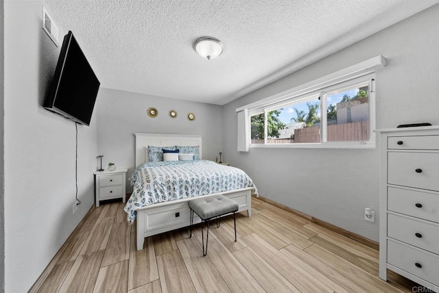 1203 Fifth Ave, Chula Vista, CA 91911 - bedroom featuring light wood-style floors and a textured ceiling