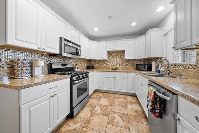 1203 Fifth Ave, Chula Vista, CA 91911 - kitchen with appliances with stainless steel finishes, tasteful backsplash, white cabinets, and recessed lighting