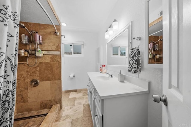 1203 Fifth Ave, Chula Vista, CA 91911 - bathroom featuring a tile shower, vanity, and stone tile floors
