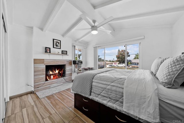 1203 Fifth Ave, Chula Vista, CA 91911 - bedroom with access to outside, a lit fireplace, light wood-style floors, and a ceiling fan