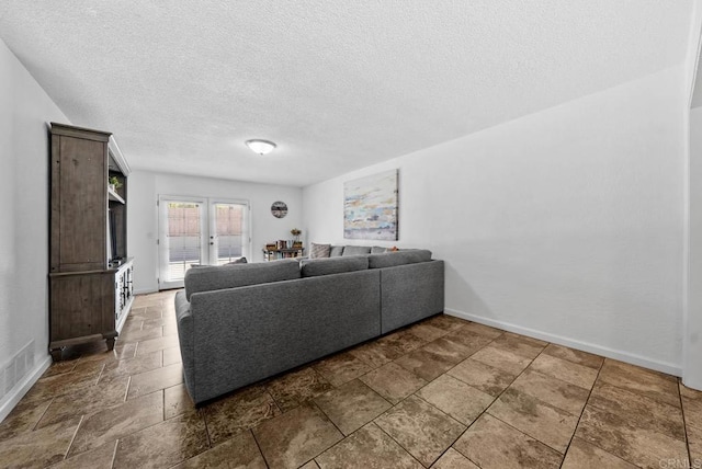 1203 Fifth Ave, Chula Vista, CA 91911 - living area featuring a textured ceiling and stone finish floors