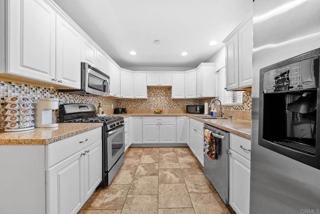 1203 Fifth Ave, Chula Vista, CA 91911 - kitchen with appliances with stainless steel finishes, tasteful backsplash, white cabinetry, light countertops, and recessed lighting