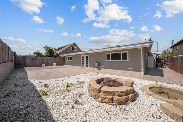 1203 Fifth Ave, Chula Vista, CA 91911 - rear view of house featuring a patio, french doors, a fenced backyard, a fire pit, and stucco siding