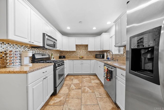 1203 Fifth Ave, Chula Vista, CA 91911 - kitchen with appliances with stainless steel finishes, white cabinetry, decorative backsplash, and recessed lighting