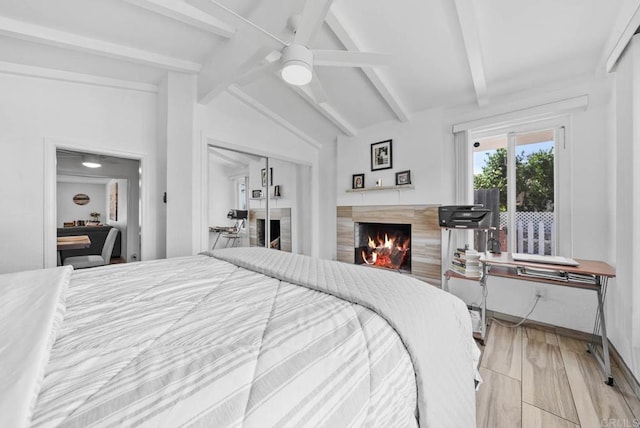 1203 Fifth Ave, Chula Vista, CA 91911 - bedroom featuring a tile fireplace, light wood-style flooring, a ceiling fan, and a closet